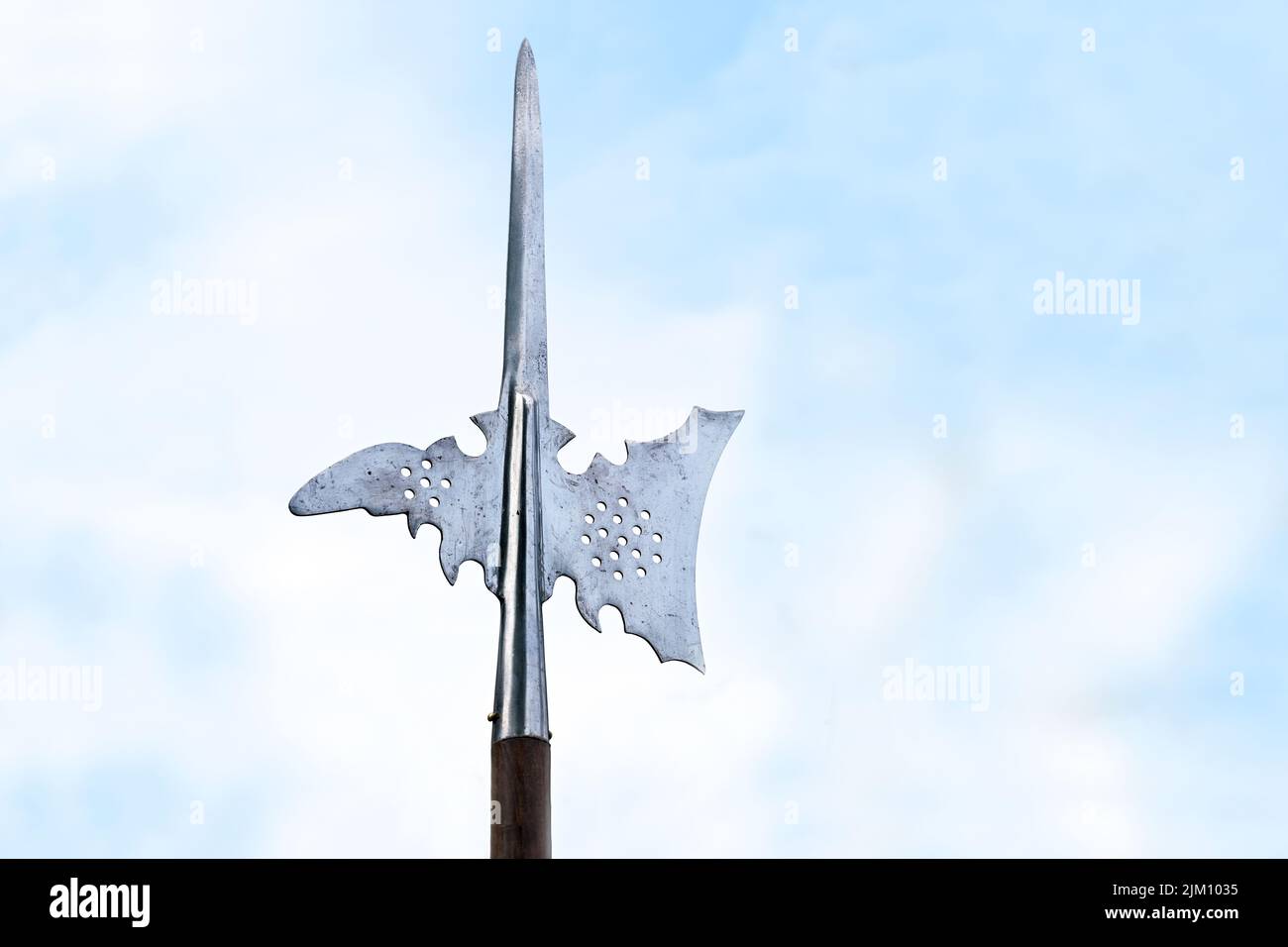 Metallspitze eines Hellebards, auch Halbard, Halbert oder Schweizer Voulge genannt, mit Axtklinge und Spitze gegen einen wolkigen blauen Himmel, Polwaffe, Kopierraum, Sel Stockfoto