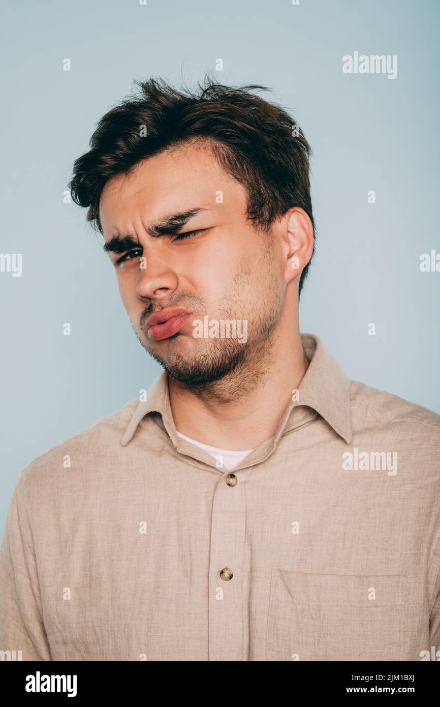 Mann kneifelt Ekel Übelkeit Gesichtsausdruck Stockfoto