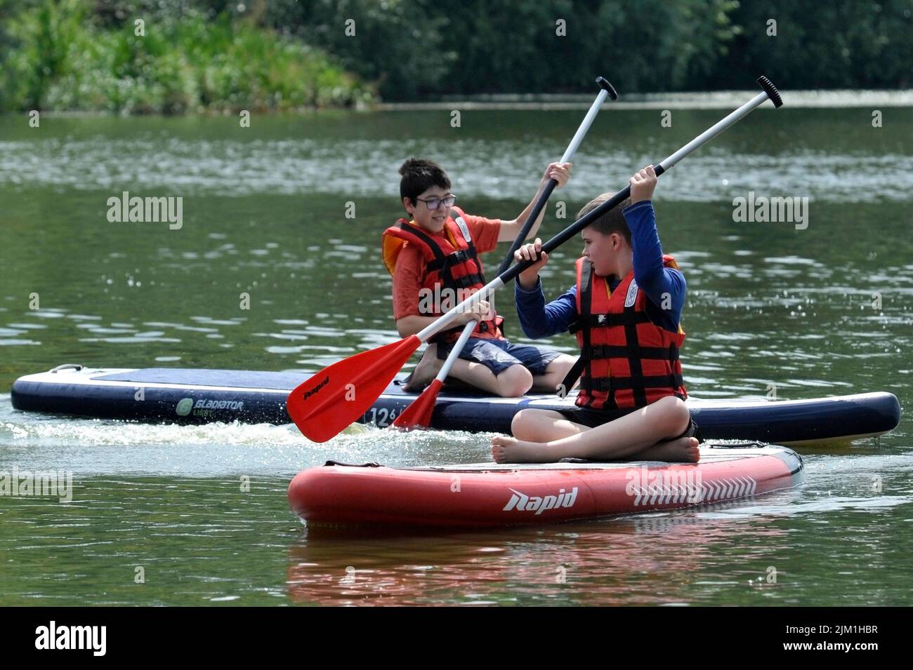 VINNYTSIA, UKRAINE - 3. AUGUST 2022 - Ein Masterclass zum Stand-up-Paddleboarding (SUP) für intern vertriebene Kinder zielt darauf ab, ihre Phys zu verbessern Stockfoto