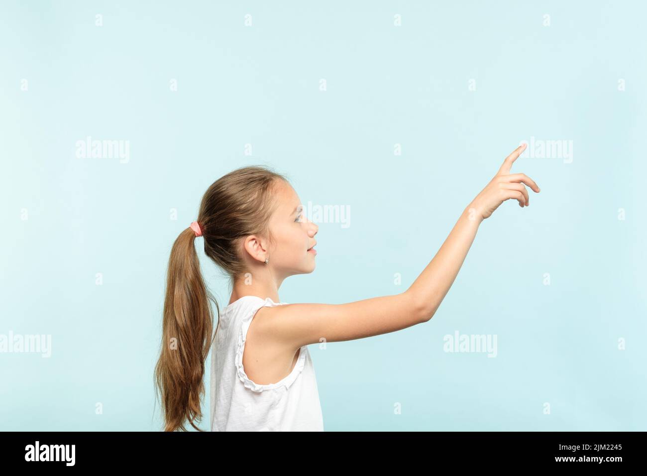 Nachdenkliches Mädchen erreicht virtuellen Knopf drücken Stockfoto