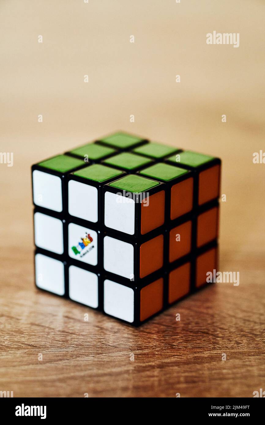 Nahaufnahme eines gelösten Rubik-Würfels, der auf einer Holzoberfläche steht. Stockfoto