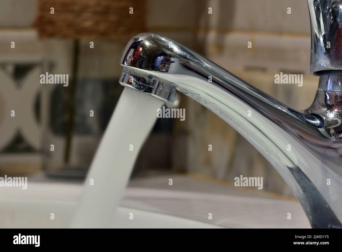 Chorro de agua cayendo de un grifo de un lavabo Stockfoto