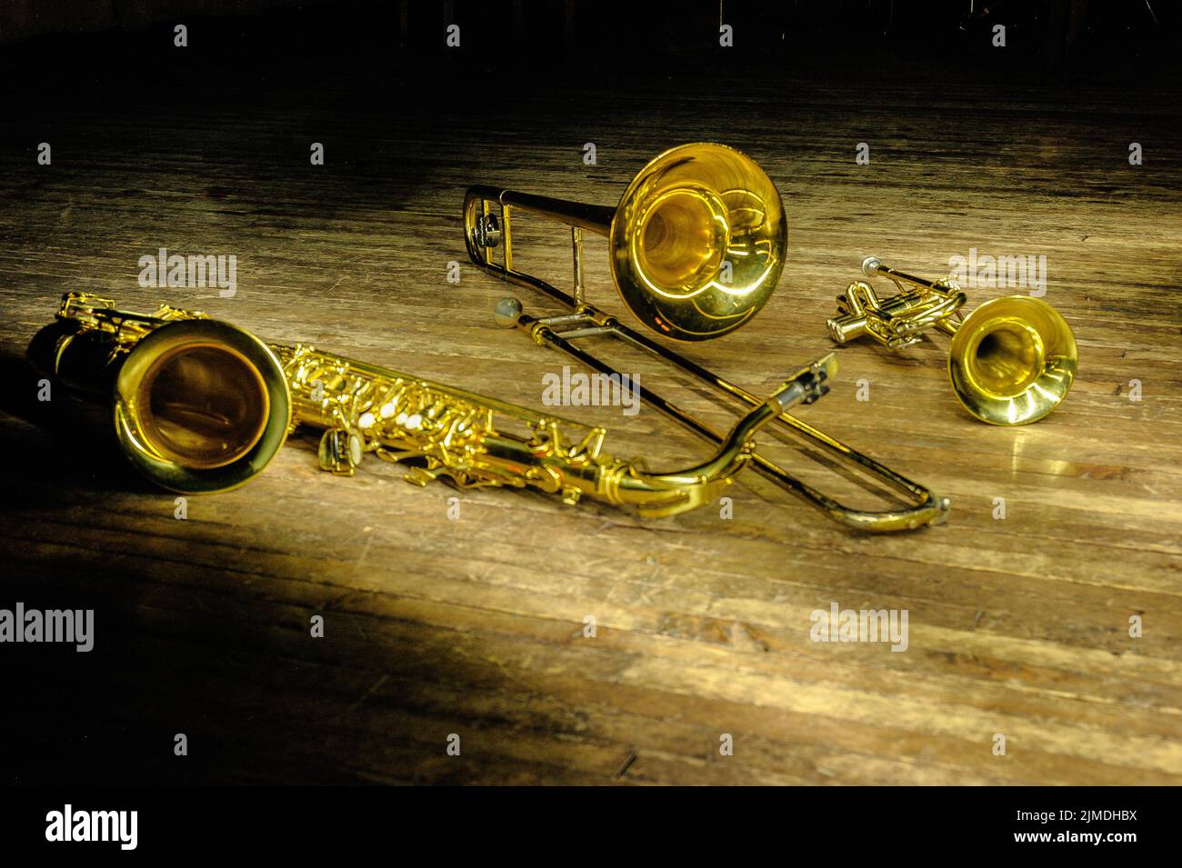 Blas- und Blasinstrumente - Saxofon, Posaune, Trompete auf der Bühne mit Hintergrundbeleuchtung Stockfoto