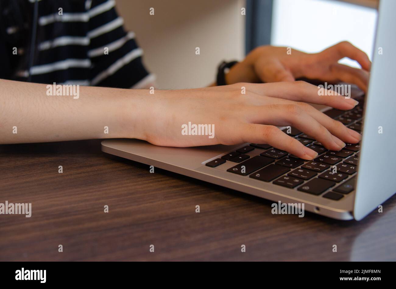 Nahaufnahme Hand Mädchen Eingabe Tastatur Computer Laptop digitale Online-Netzwerk Kommunikation Internet auf dem Tisch. Stockfoto