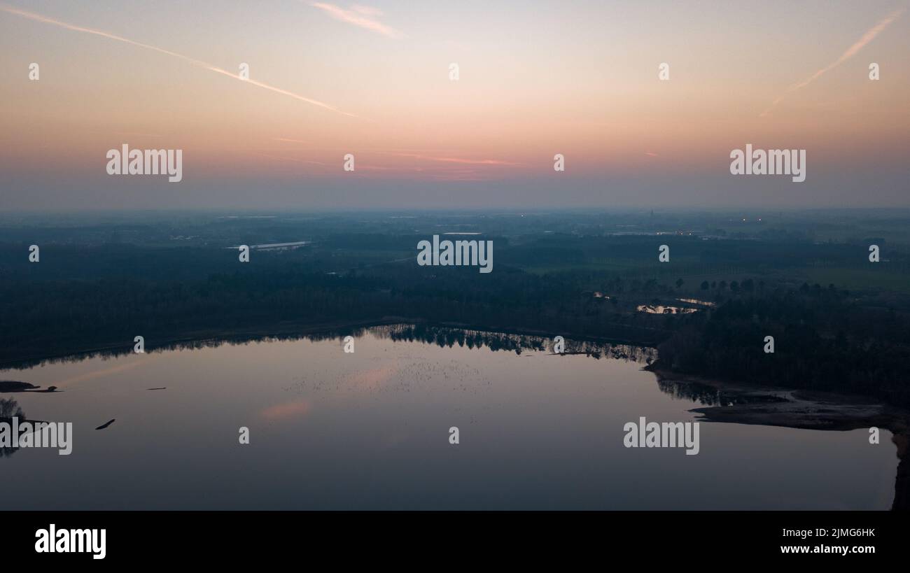 Luftaufnahme von einer Drohne eines wunderschönen dramatischen und farbenfrohen Sonnenuntergangs an der Küste des Sees. Naturlandschaft. Natur in Europa Stockfoto