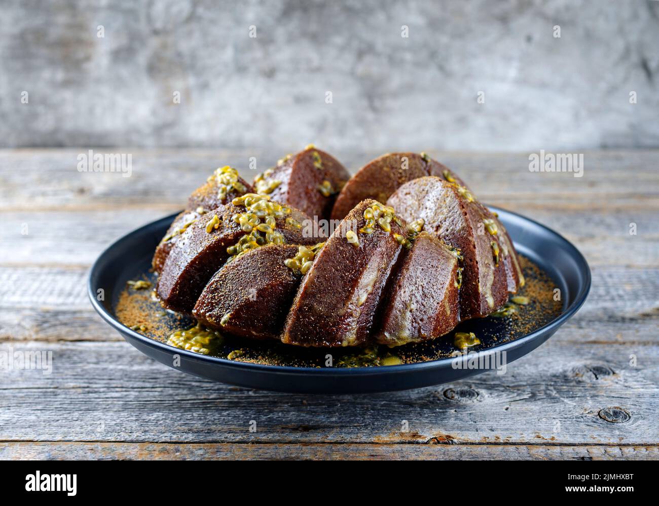 Exotisch gebundener Marble Passionsfrucht-Rum-Kuchen mit Puderzucker-Glasur Stockfoto