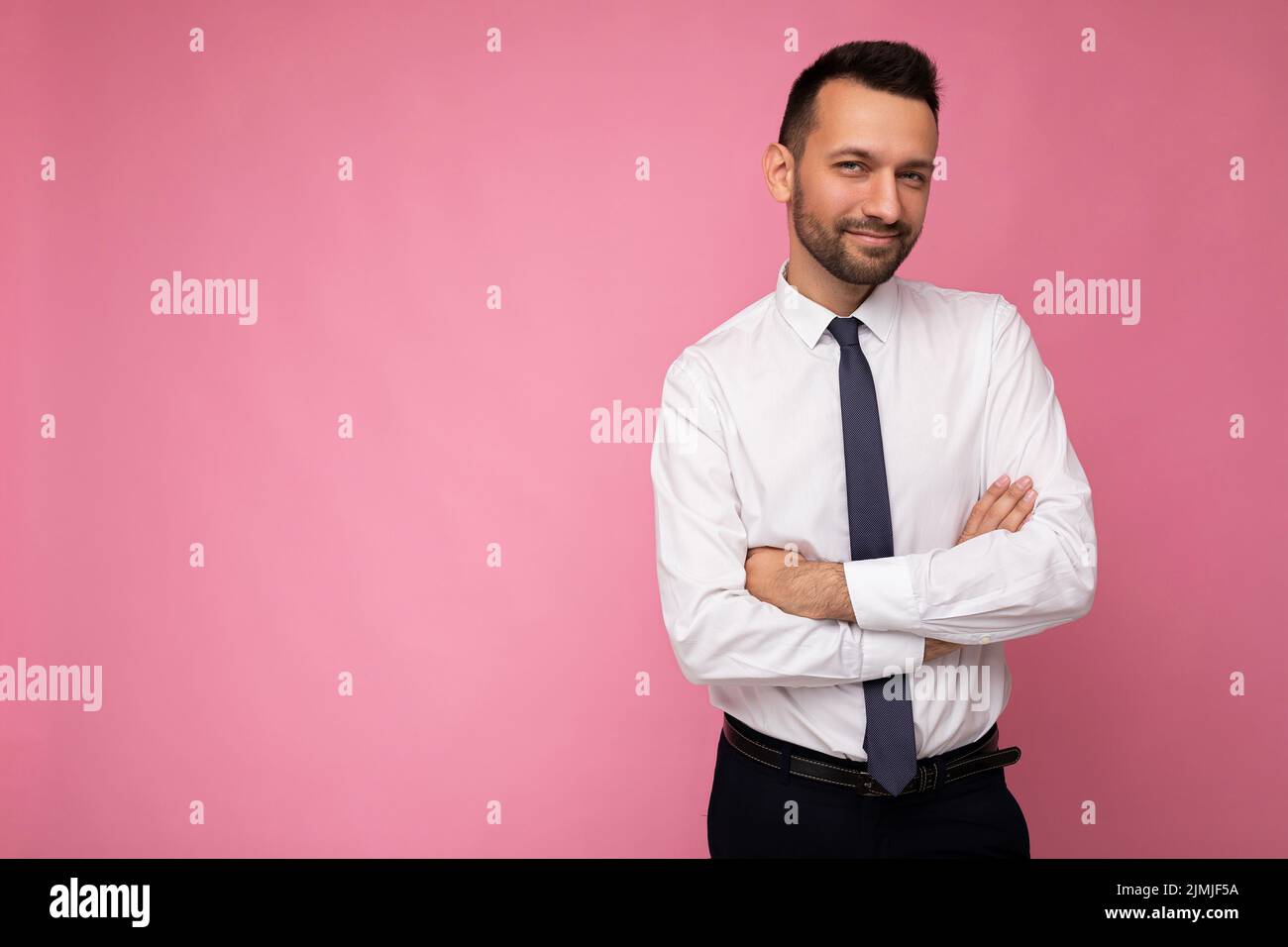 Foto von gutaussehenden zuversichtlich positive Brunet Mann in lässigen weißen Hemd isoliert auf rosa Hintergrund mit Platz für Text kopieren Stockfoto