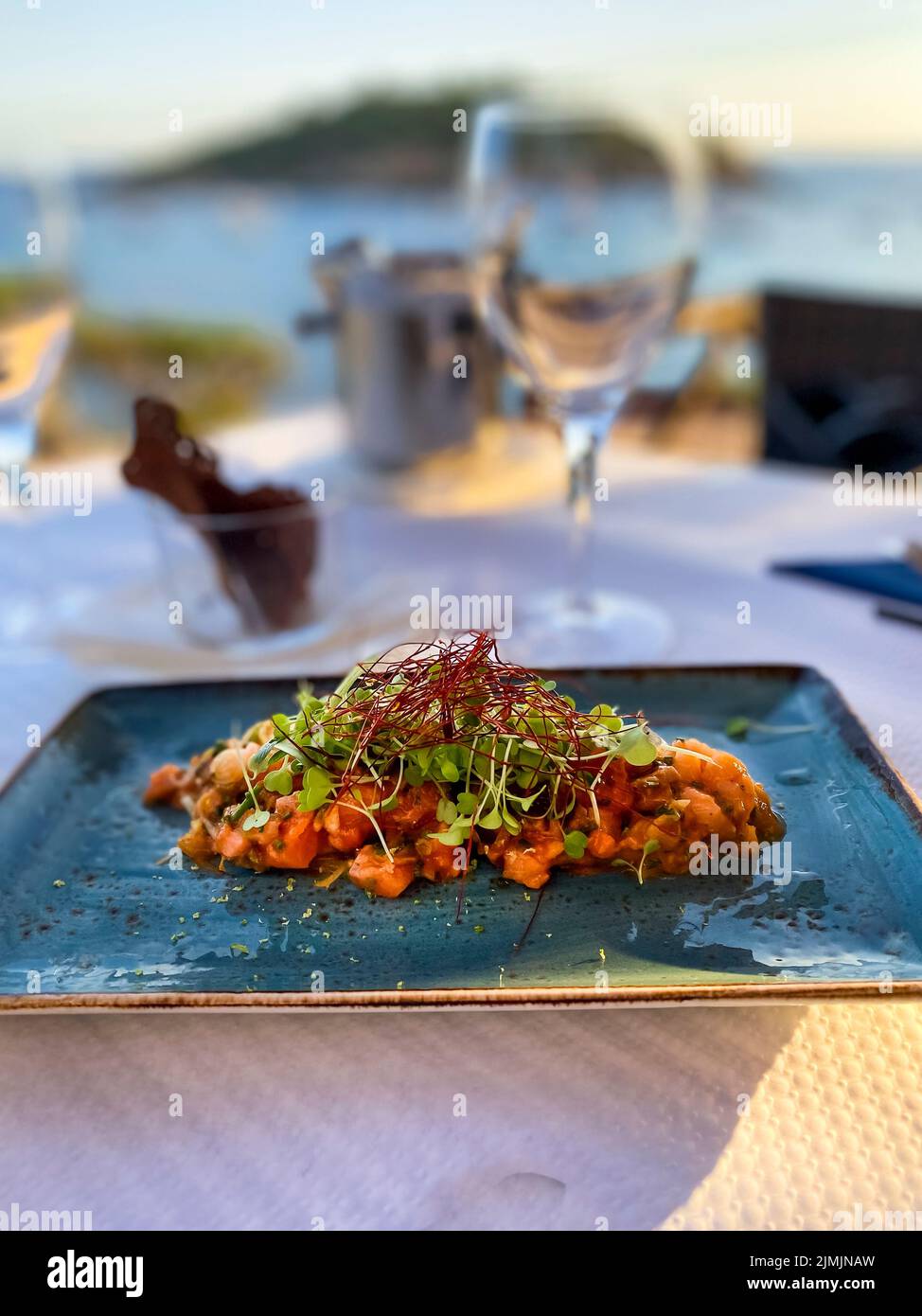 Spanien, Mallorca, Sant Elm, Lachs-Tartare in der Abendsonne am Meer Stockfoto