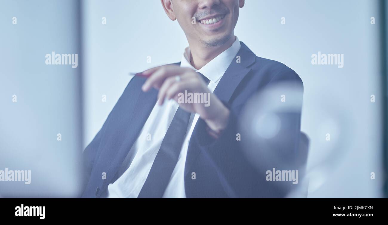 Nahaufnahme eines lächelnden und selbstbewussten jungen Geschäftsmannes Stockfoto