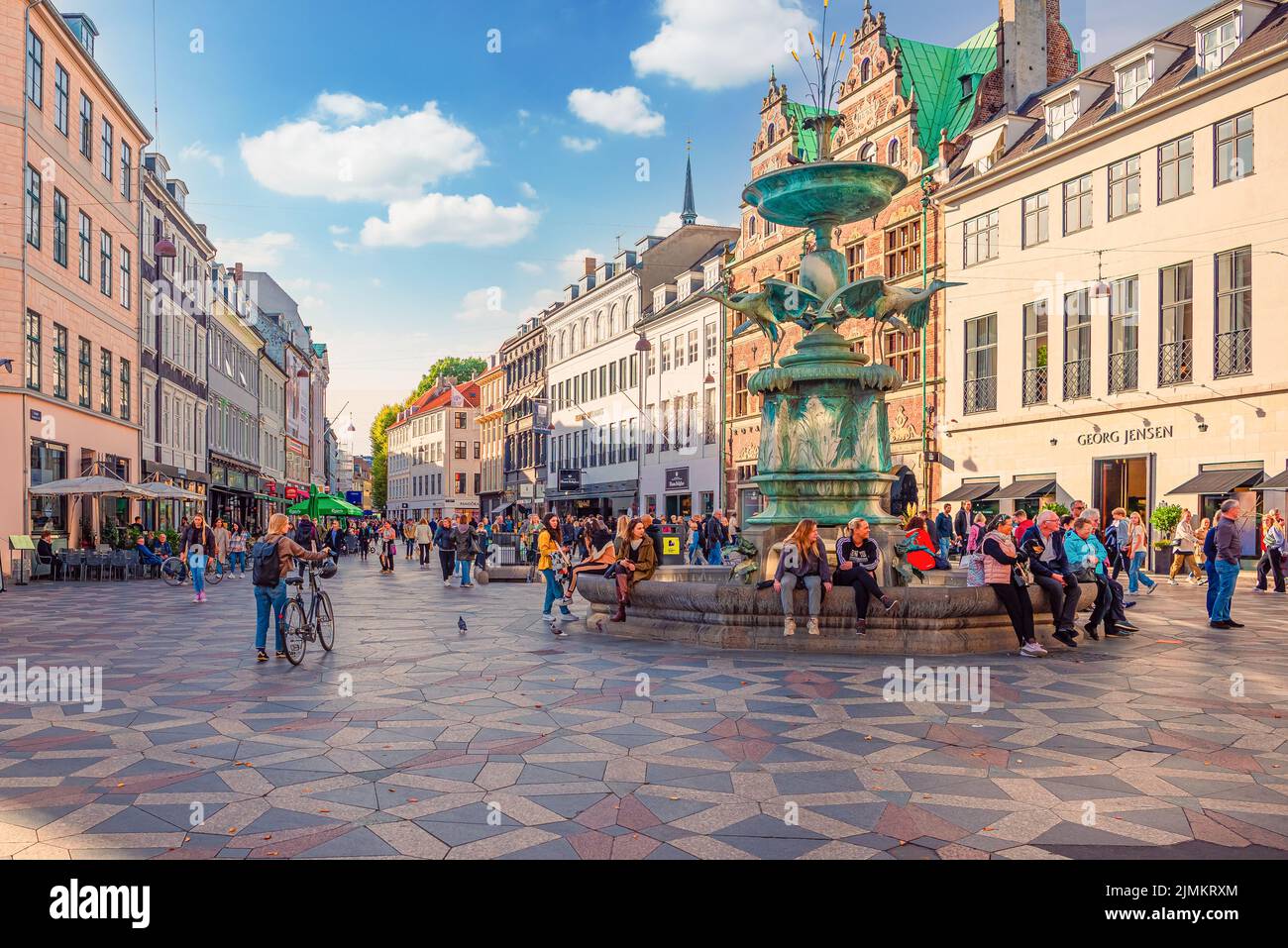 Viele Menschen gehen und sitzen in der Nähe Storch Brunnen auf Amager Platz Amagertorv an der StrÃ¸get Fußgängerzone. Kopenhagen, Dänemark Stockfoto