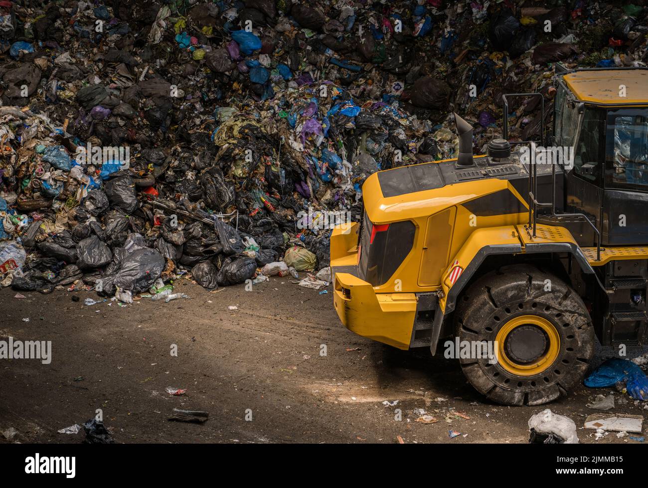 Umgang mit riesigen Haufen Müll mit einem Bulldozer. Anlagen Zur Abfallsortierung. Recycling-Thema. Stockfoto