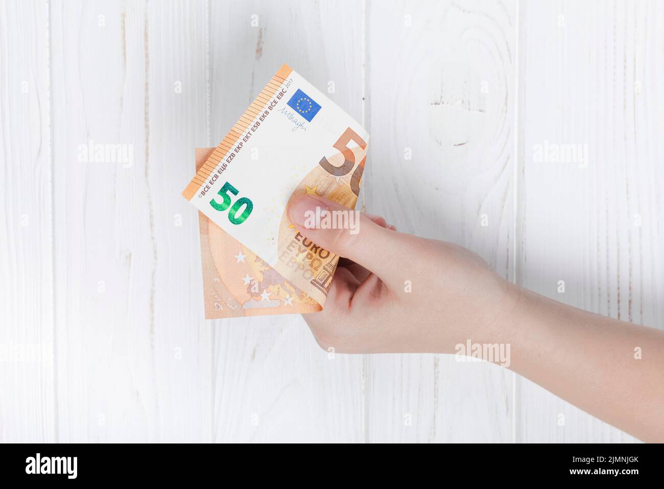 Hand hält Euro-Banknote Stockfoto