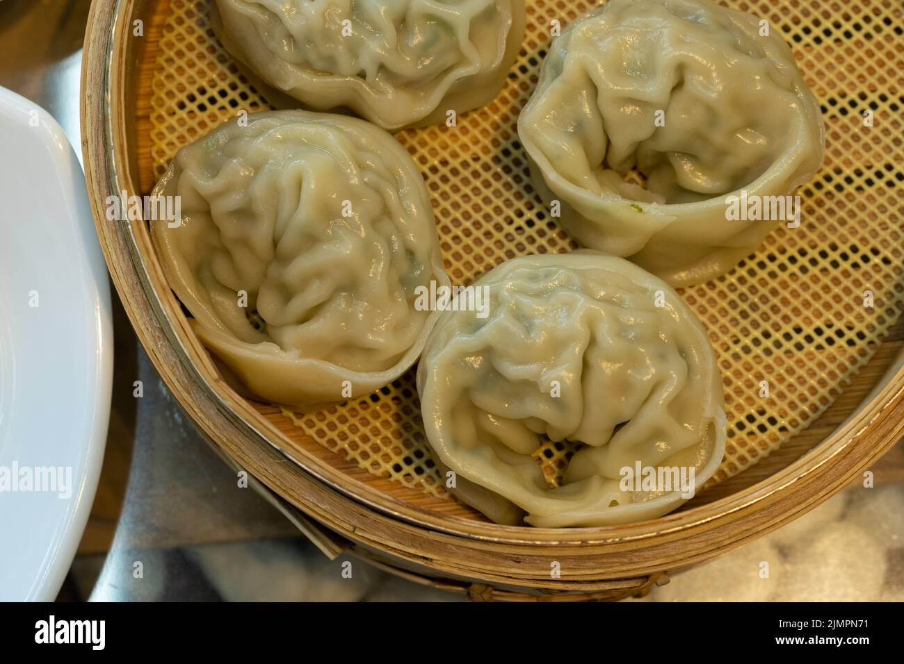 Gedämpfte Knödel in einem Dampfkorb aus Bambus. Stockfoto