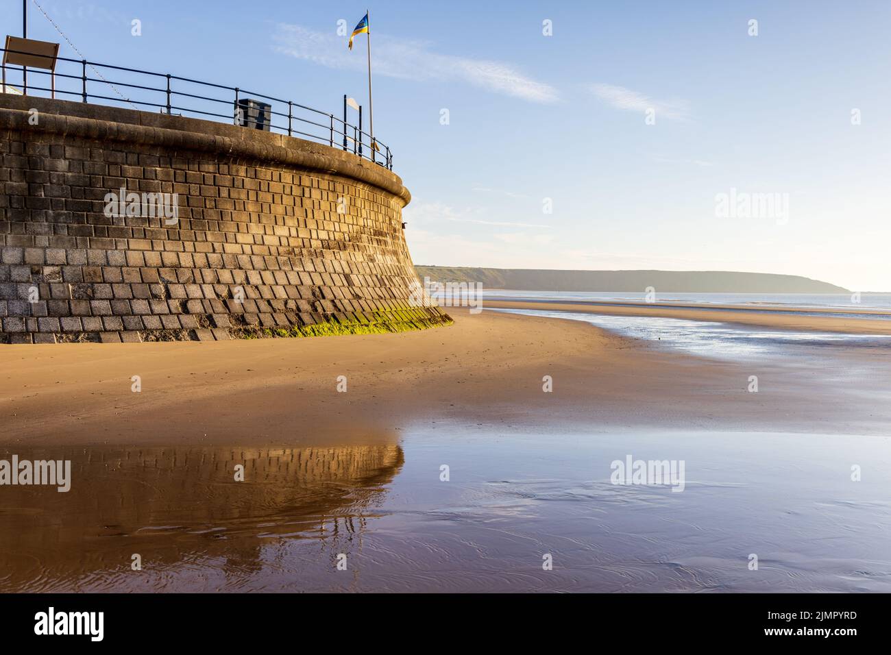 Die hohe Ufermauer und der Sandstrand von Filey an einem wunderschönen Sommermorgen an der Yorkshire Küste in england. Stockfoto