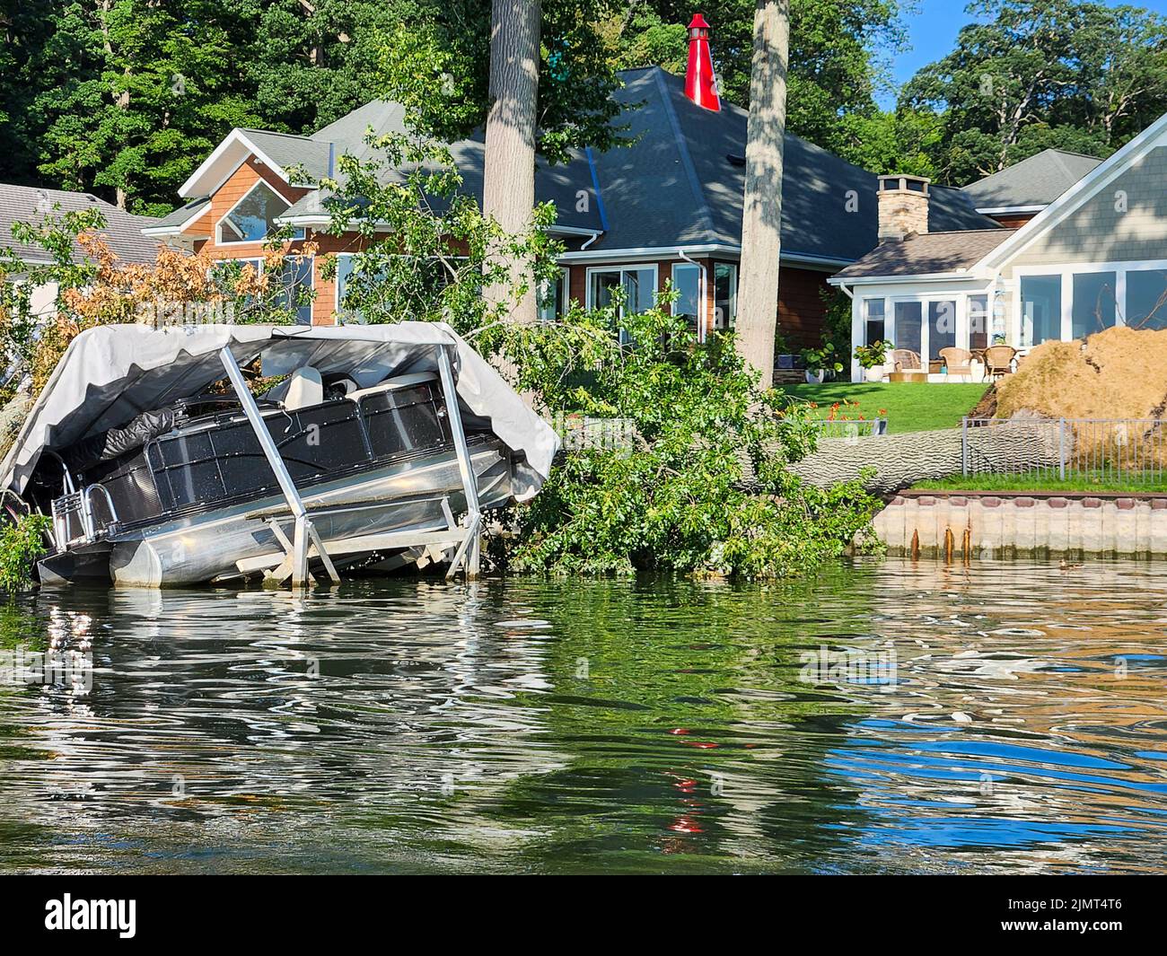 Pontonboot von einem umgestürzten Baum zerquetscht Stockfoto