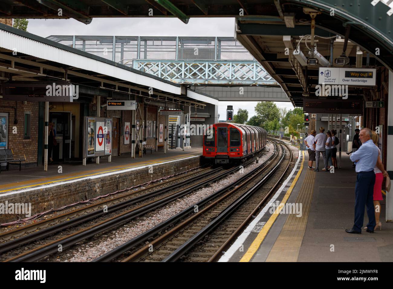 Eine U-Bahn fährt von der U-Bahn-Station Debden ab. Geschäftige Londoner U-Bahn-Station wegen begrenzter Service, am Tag nach einem Streik der Bahnarbeiter Stockfoto