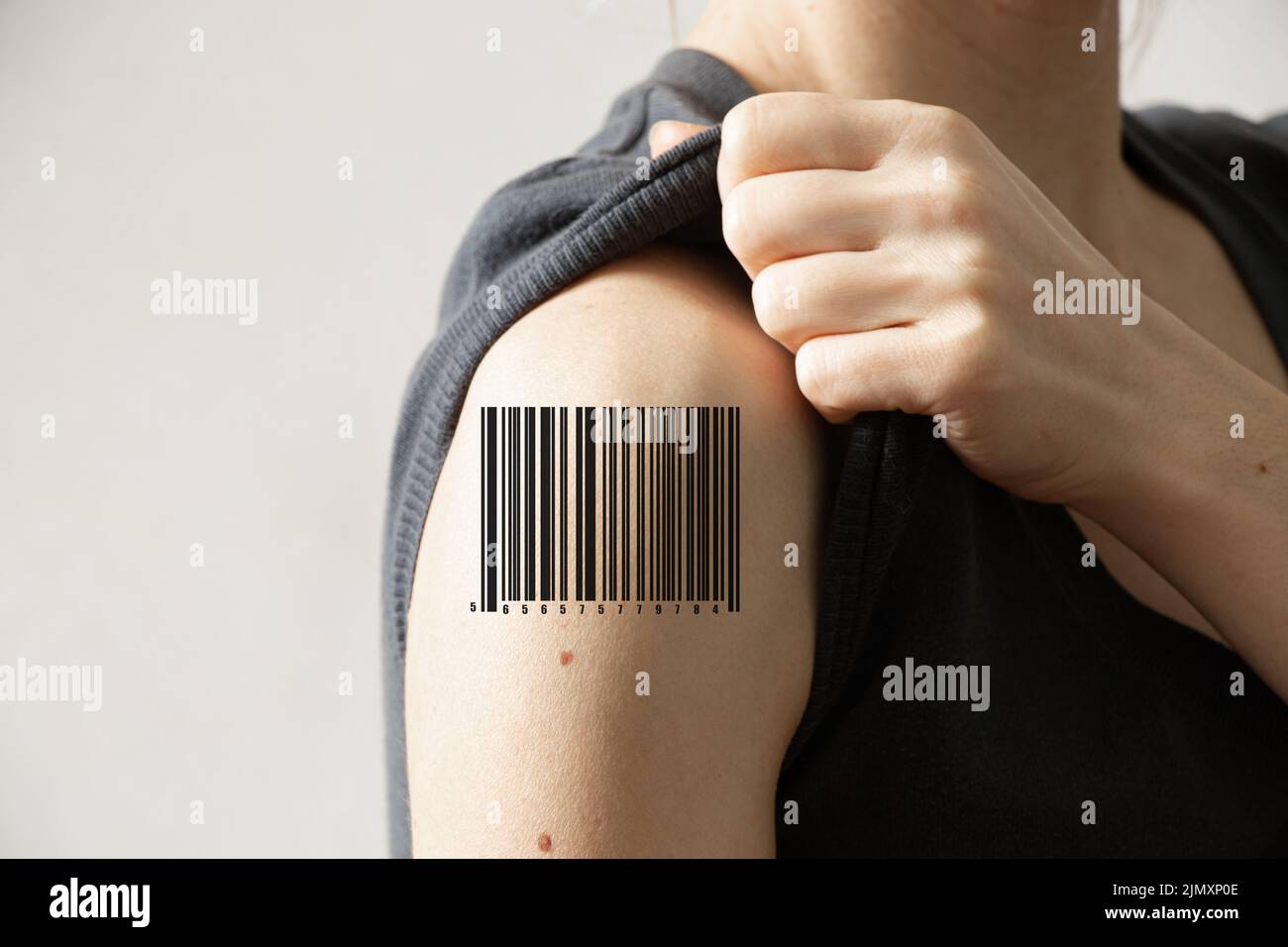 Ein Barcode auf der Schulter eines Mädchens, Menschen sind Sklaven und nicht frei, Menschen, die klammern Stockfoto