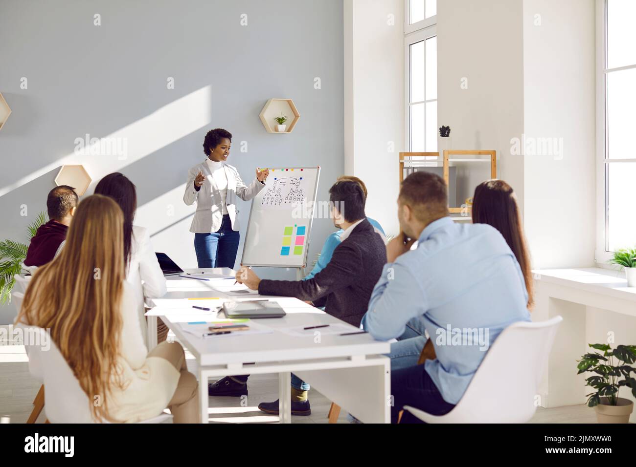 Freundliche Geschäftsfrau spricht während des Bürotreffens über neue Marketingstrategie. Stockfoto