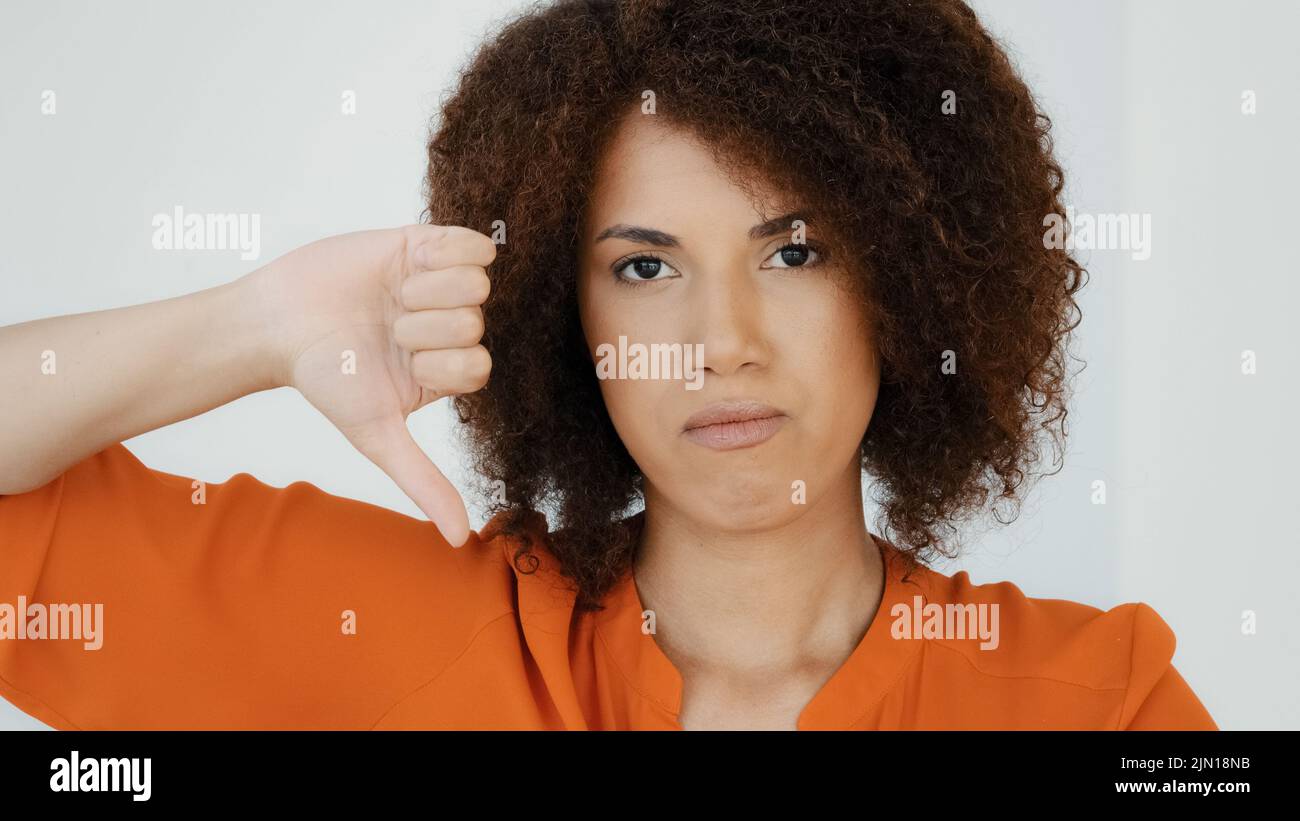 Nahaufnahme African American Millennial traurig frustriert enttäuschte Frau mit lockigem Haar Mädchen suchen Kamera zeigt Abneigung Daumen nach unten Uneinigkeit Stockfoto