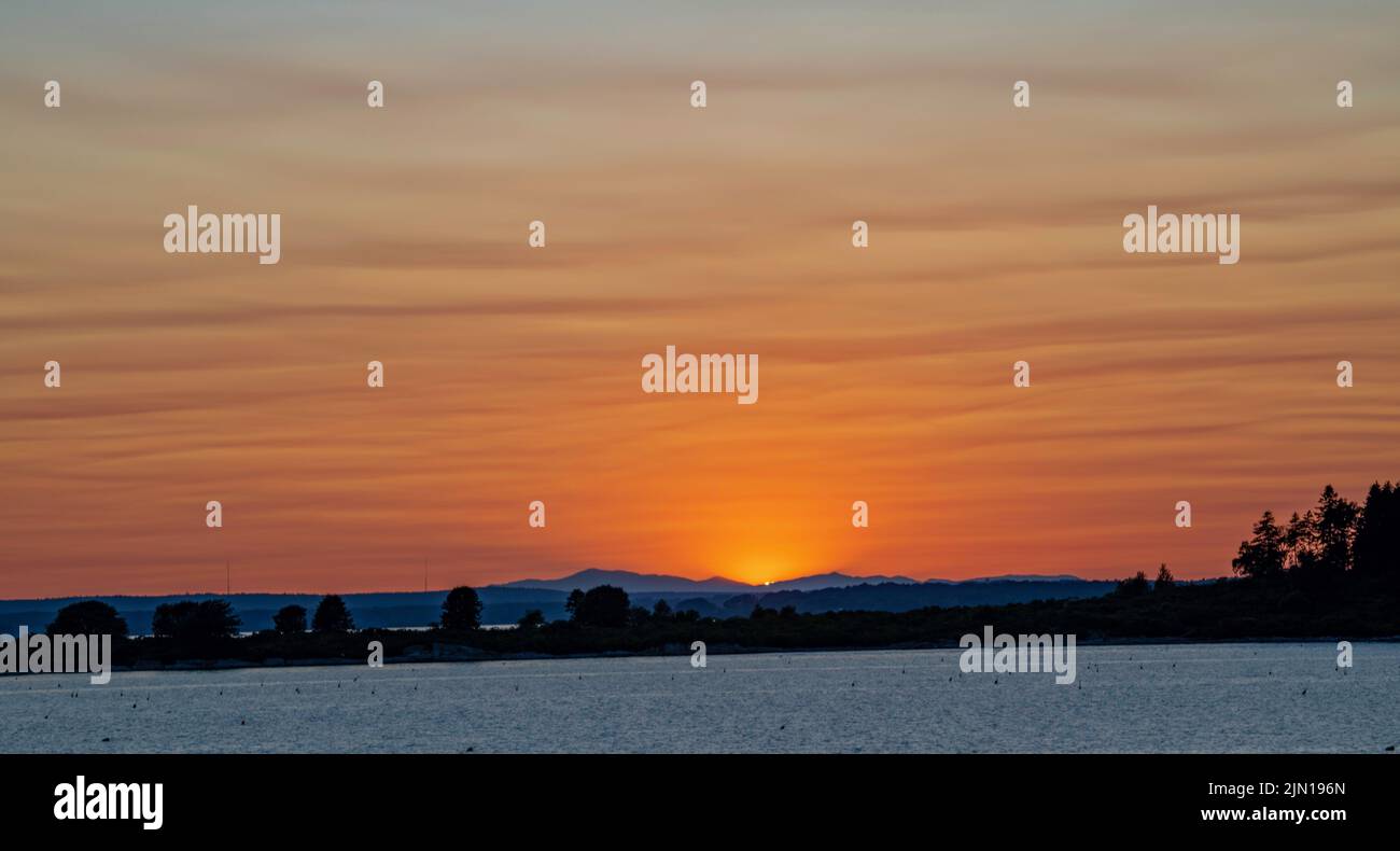 9. Juli 2022. 8:18 Uhr. Blick auf die Presidential Range bei Sonnenuntergang. Barnes Island. Casco Bay. Maine. Stockfoto