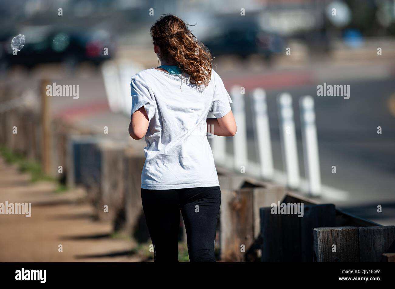 Das Bild einer Frau auf ihrem Morgenlauf. Trail Runner, Beach Runner, San Francisco, Kalifornien, Westküste, Gesundheit, Wellness, Bewegung Stockfoto