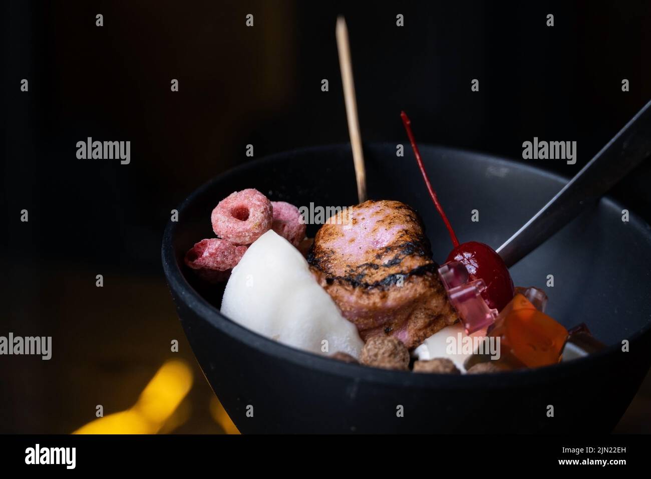 Eine Nahaufnahme eines köstlichen koreanischen Eisdessertals mit süßen Belägen - Erdbeer-Bingsoo mit Mooslaibe und Panda-förmigen Gummitüssen Stockfoto