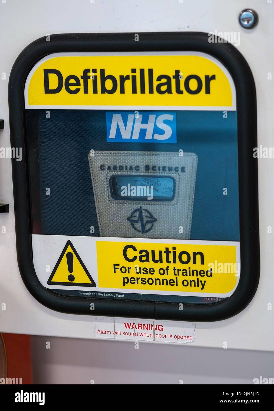 London, Vereinigtes Königreich - 05. Februar 2019: Hellgelbes Warnschild auf der automatisierten externen Defibrillatorbox, die in der Nähe an der Wand des Einkaufszentrums angebracht ist Stockfoto