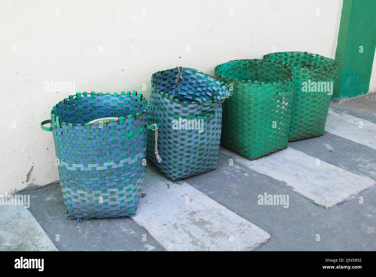 Korb, Plastikkorb dient als Mülleimer.Mülleimer kann draußen gegen die Wand Stockfoto