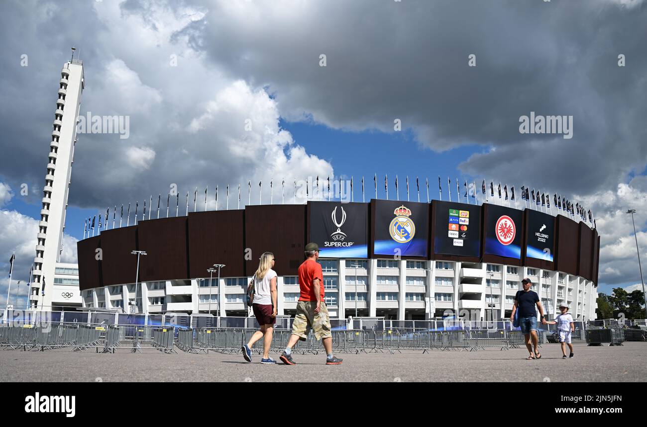 Helsinki, Finnland. 09. August 2022. Fußball: UEFA, Super Cup, vor dem Real Madrid - Eintracht Frankfurt Spiel im Olympiastadion in Helsinki. Passanten laufen am Olympiastadion vorbei, dem Austragungsort der Olympischen Sommerspiele 1952. Am 10. August 2022 spielen Champions League-Sieger Real Madrid und Europa League-Sieger Eintracht Frankfurt für den UEFA-Supercup. Kredit: Arne Dedert/dpa/Alamy Live Nachrichten Stockfoto