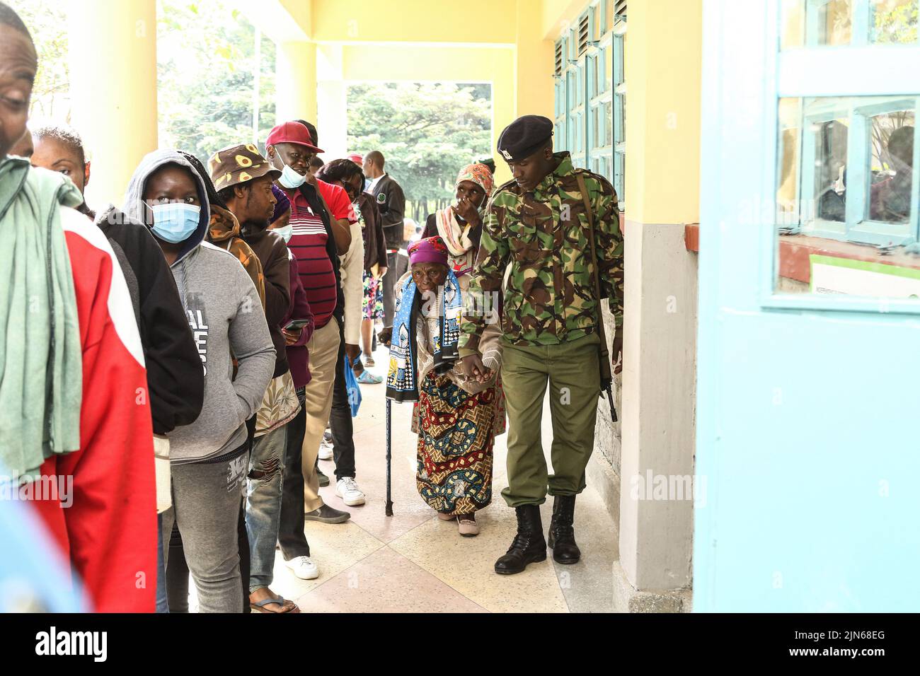 Nakuru, Kenia. 09. August 2022. Der Polizeibeamte Gilbert Langat, 32, hilft Esther Thira, 77, Während der Parlamentswahlen in Kenia können Sie das Wahlgebiet der Nakuru Boys High School im Wahlkreis Nakuru Town East besuchen. Die Kenianer haben am Dienstagmorgen, dem 9. August 2022, mit der Wahl ihres bevorzugten Präsidenten und der Mitglieder der nationalen und der Bezirksversammlungen begonnen. (Foto von James Wakibia/SOPA Images/Sipa USA) Quelle: SIPA USA/Alamy Live News Stockfoto