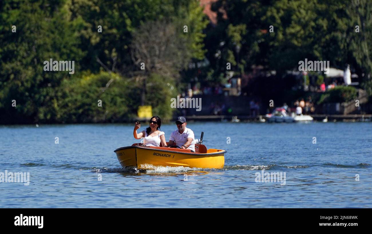 Die Menschen auf einem Boot auf der Themse in Windsor, während ein Sommer voller Rohrleitungsverbote und Feuerwarnungen anhält, wobei in weiten Teilen des Landes ein Warnsignal für die Hitzeentwicklung aufkommt. Bilddatum: Dienstag, 9. August 2022. Stockfoto