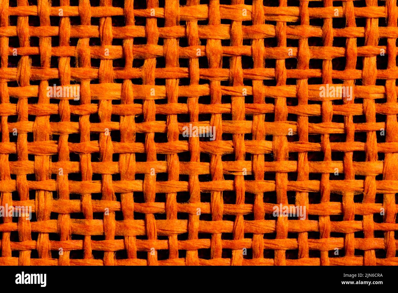 Nahaufnahme der orange gewebten Materialstruktur Stockfoto