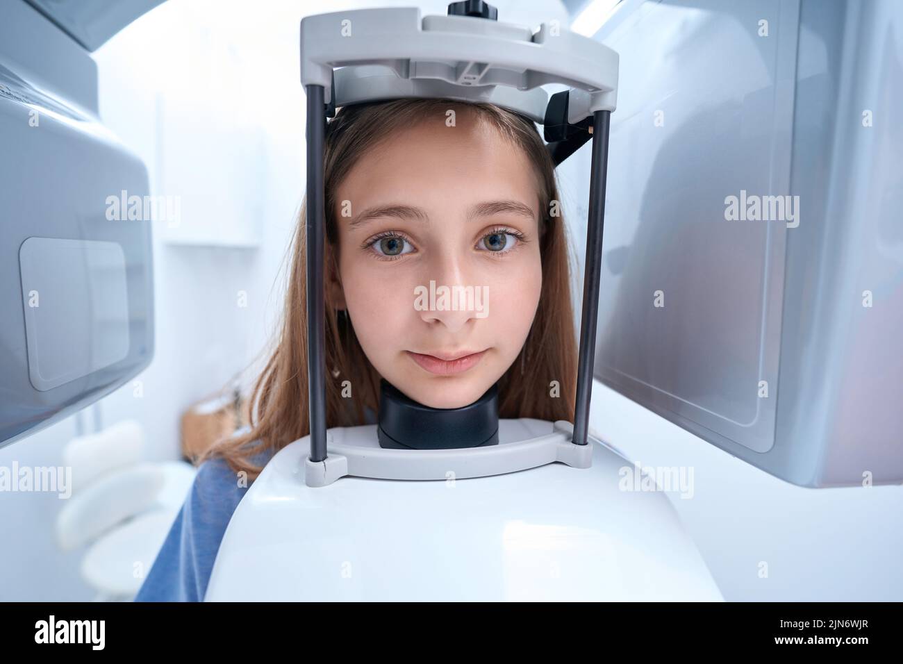 Ruhige weibliche Patientin, die sich einer zahnmedizinischen Radiographie unterziehen muss Stockfoto