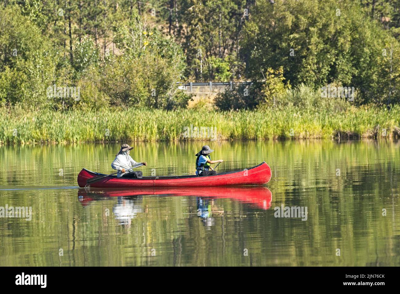 Ein redaktionelles Foto eines reifen Paares, das auf dem Coeur d'Alene Lake im Norden von Idaho mit dem Kanu paddelt. Stockfoto