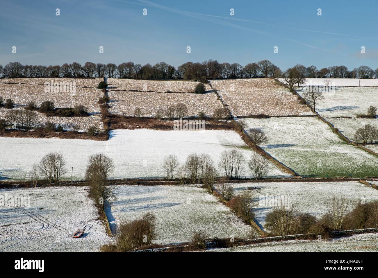 Ein leichter Schneefall bedeckt das Patchwork der Felder in der Nähe von Belper, Derbyshire, England Stockfoto