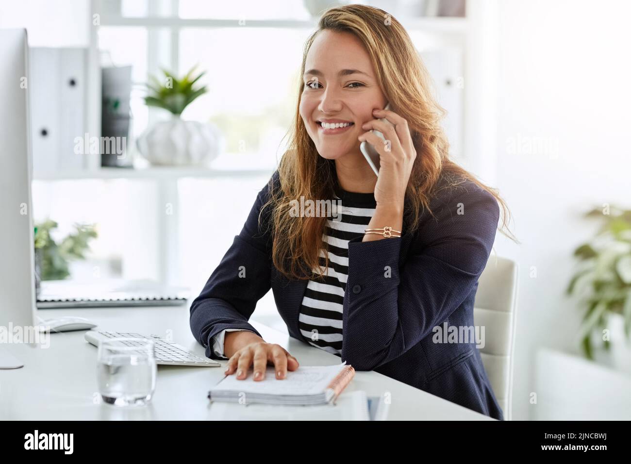 Wir bearbeiten heute alle Kundenbeziehungen. Porträt einer attraktiven Geschäftsfrau, die an ihrem Schreibtisch einen Anruf entgegennimmt. Stockfoto