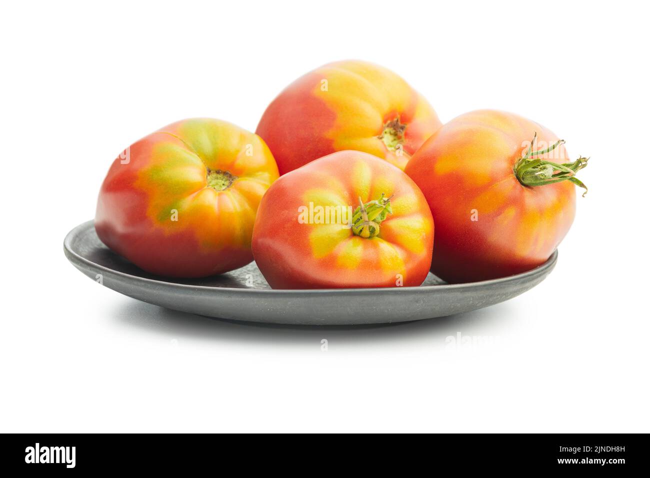 Bullherz-Tomaten isoliert auf weißem Hintergrund. Stockfoto