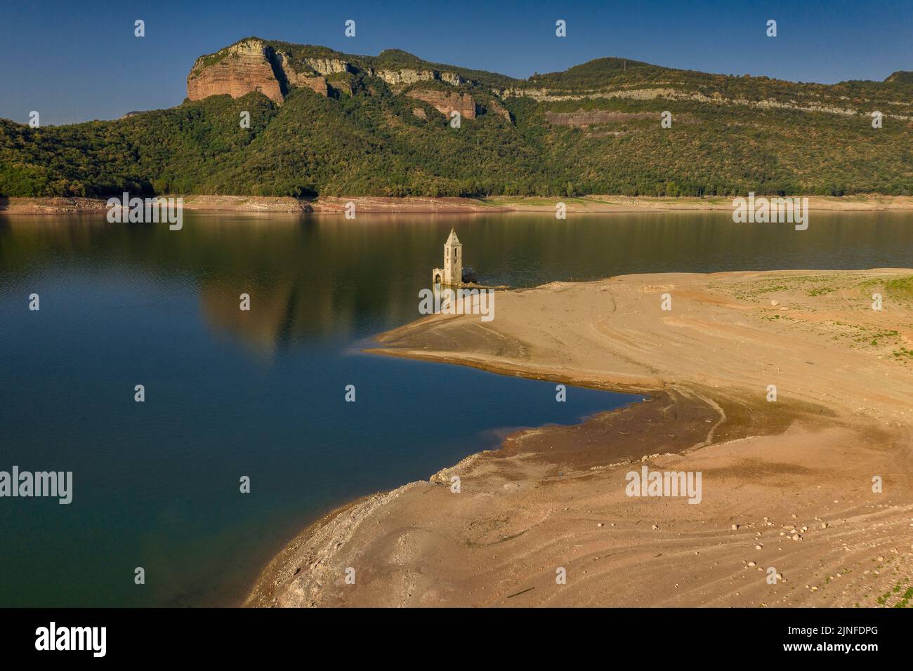 Luftaufnahme des Glockenturms von Sant Romà de Sau und des Sau-Stausees während der Sommertrockenheit von 2022 (Osona, Barcelona, Katalonien, Spanien) Stockfoto