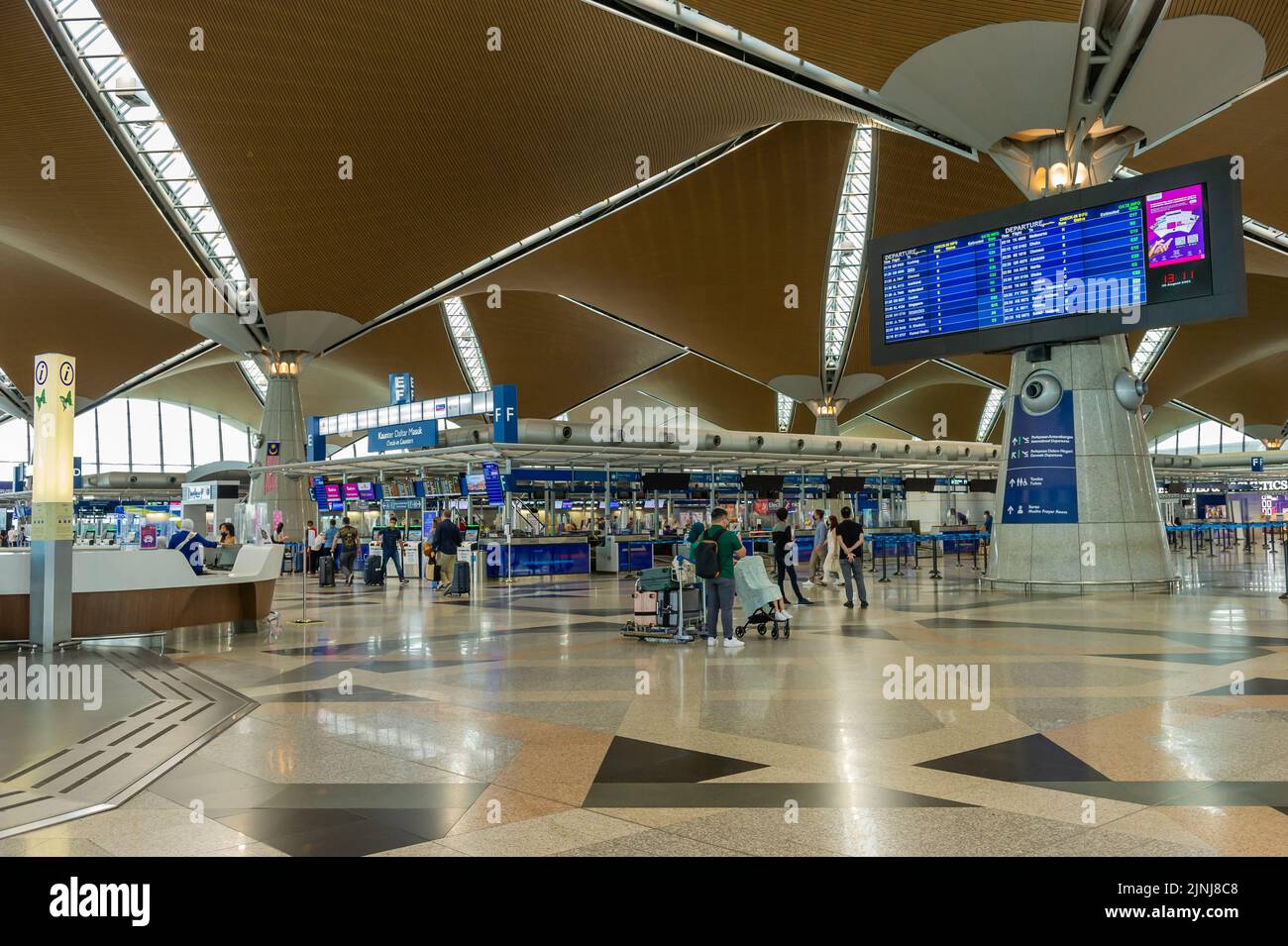 Abflug vom internationalen Flughafen Kuala Lumpur (KLIA). Check-in, Informationsschalter und Flugplananzeige Stockfoto