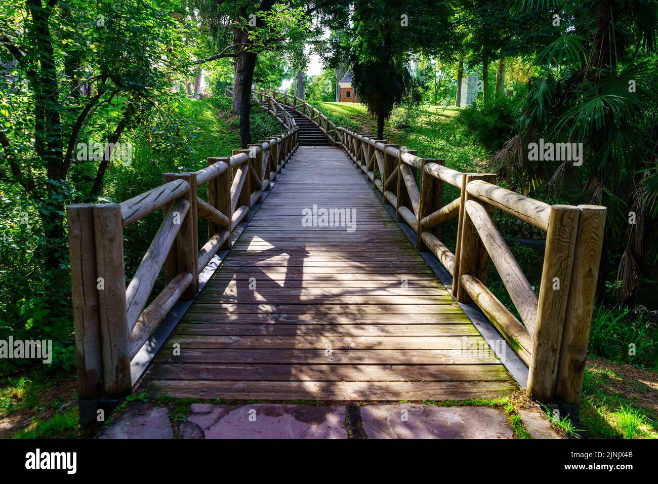 Holzbrücke über einen kleinen Bach im Retiro öffentlichen Park, Madrid. Stockfoto