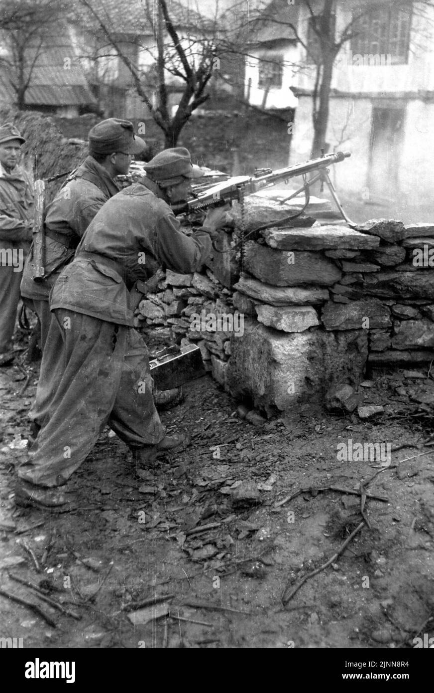 B&W-Foto aus dem 2. Weltkrieg Deutsche Bergtruppen greifen die Partisanen auf dem Balkan mit einem MG42 1944 an Stockfoto