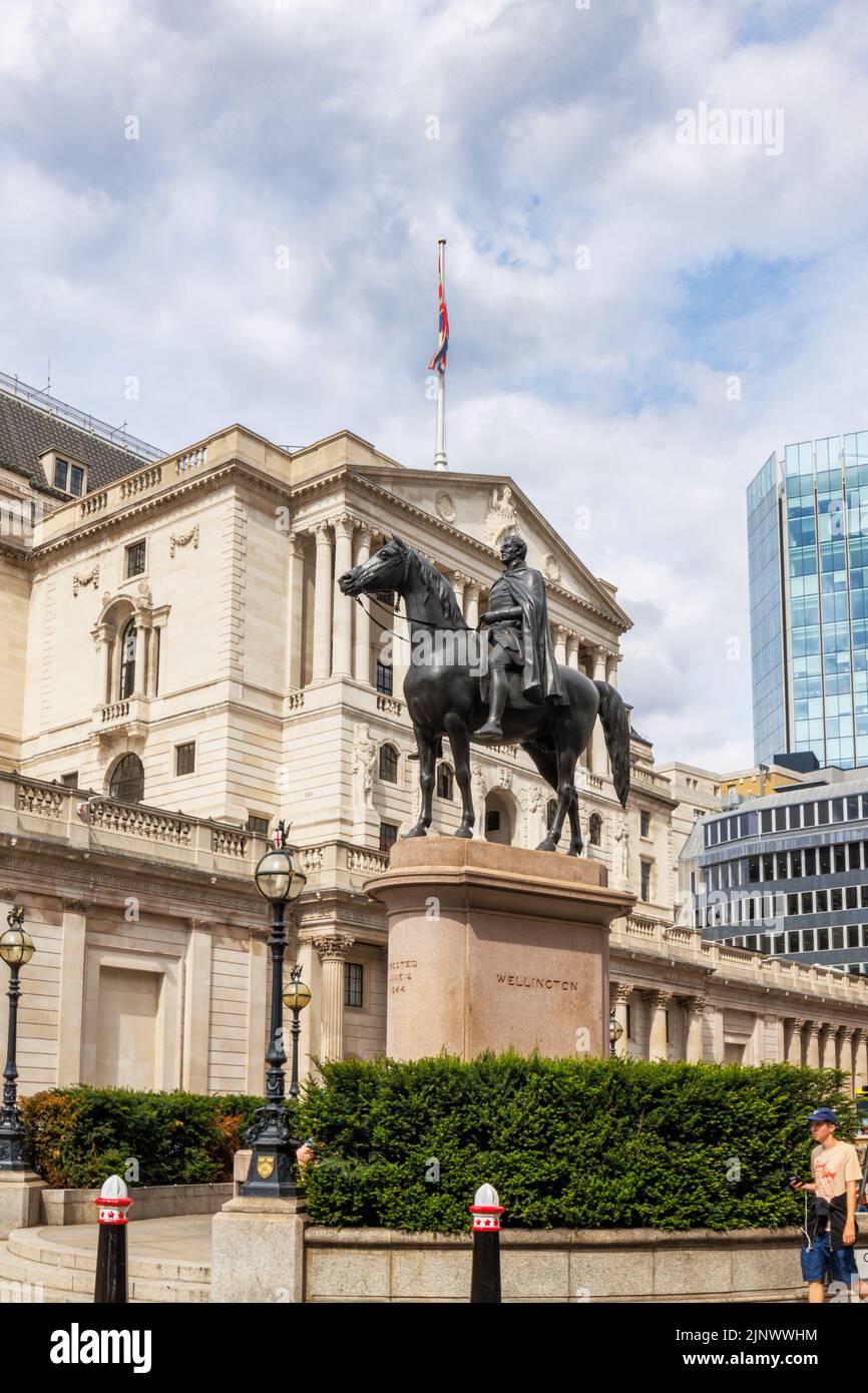 Statue des Herzogs von Wellington, die vor der Royal Exchange auf einem Pferderücken steht, und Blick auf die Fassade der Bank of England in der City of London EC3 Stockfoto