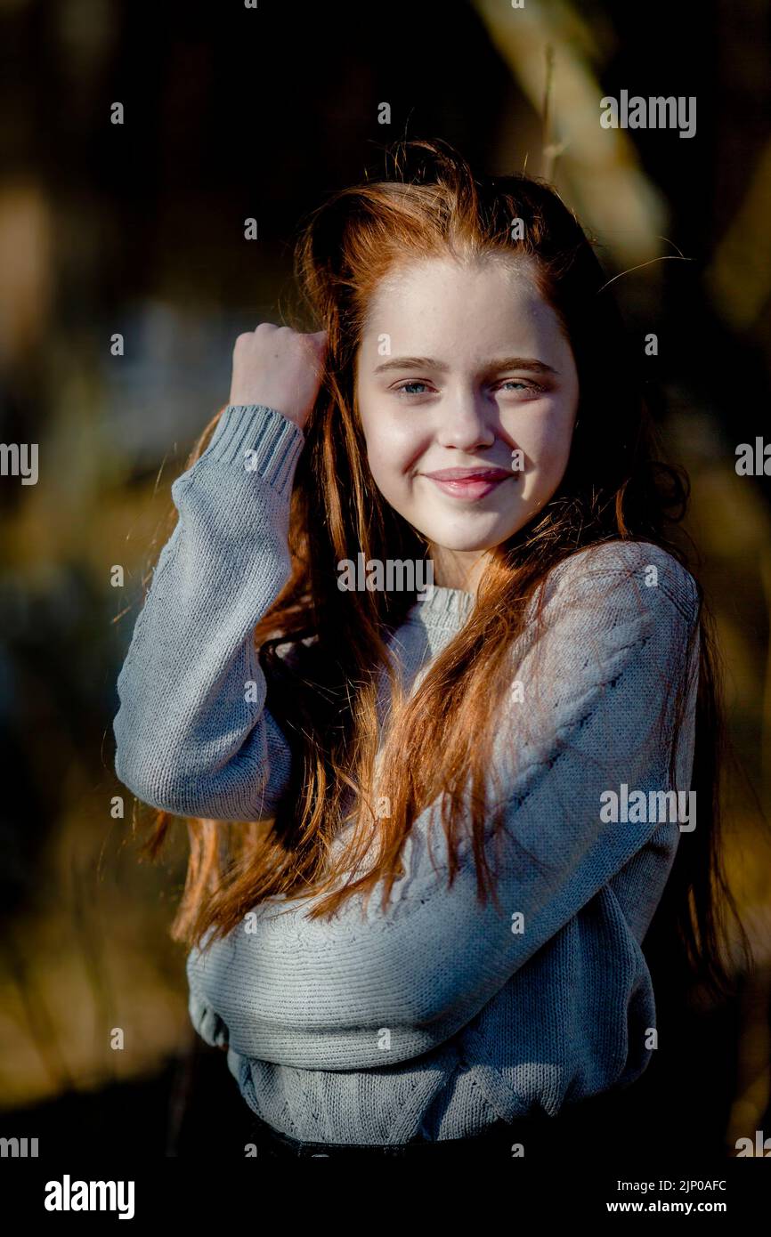 Ein langhaariges rothaariges Teenager-Mädchen im Park. Stockfoto