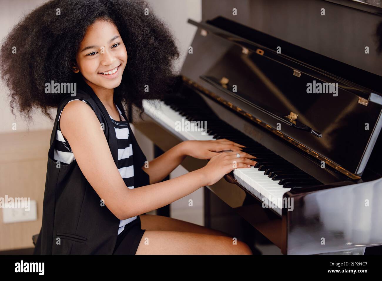 Afrikanische schwarze Kinder spielen Klaviermusik Instrument glücklich lächelnd. Stockfoto