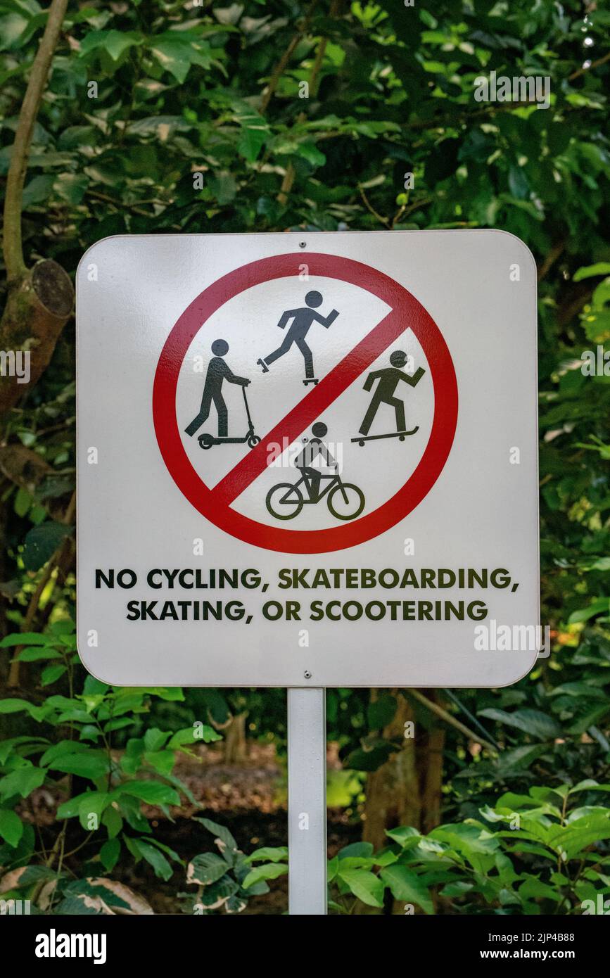 Kein Fahrrad-, Skateboarding-, Skating- oder Scootering-Zeichen in den Botanischen Gärten, Singapur. Vertikale Aufnahme Stockfoto