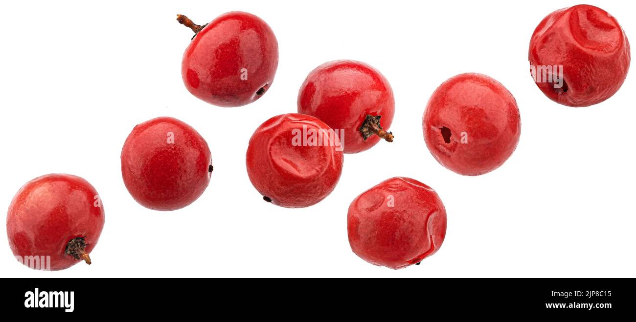 Fallende rote Pfefferkörner isoliert auf weißem Hintergrund Stockfoto