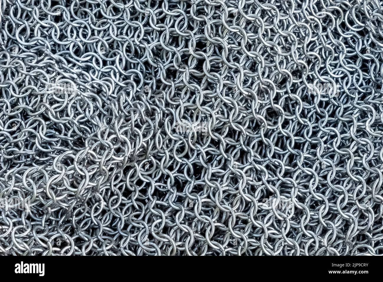 Chain Mail Hintergrundtextur, die als Körperpanzerung in Krieg und Schlacht von römischer bis mittelalterlicher Zeit in der Geschichte verwendet wurde, Stock Foto Bild Stockfoto