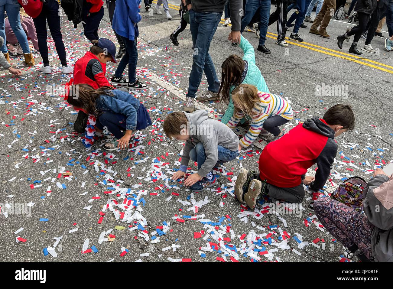 ATLANTA, GA – 5. NOVEMBER: Nach der Parade zur Weltmeisterschaft der Atlanta Braves am 5. November 2021 sammeln Kinder Konfetti von der Straße. Stockfoto