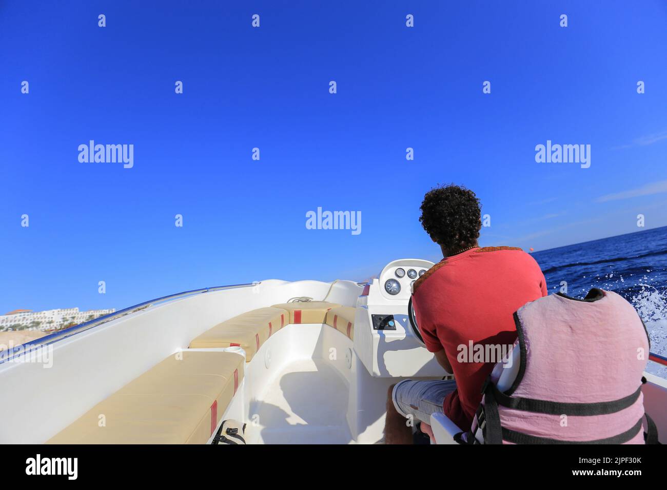 Mann, der ein Schnellboot fährt, Blick von einem Motorboot nach vorne Stockfoto