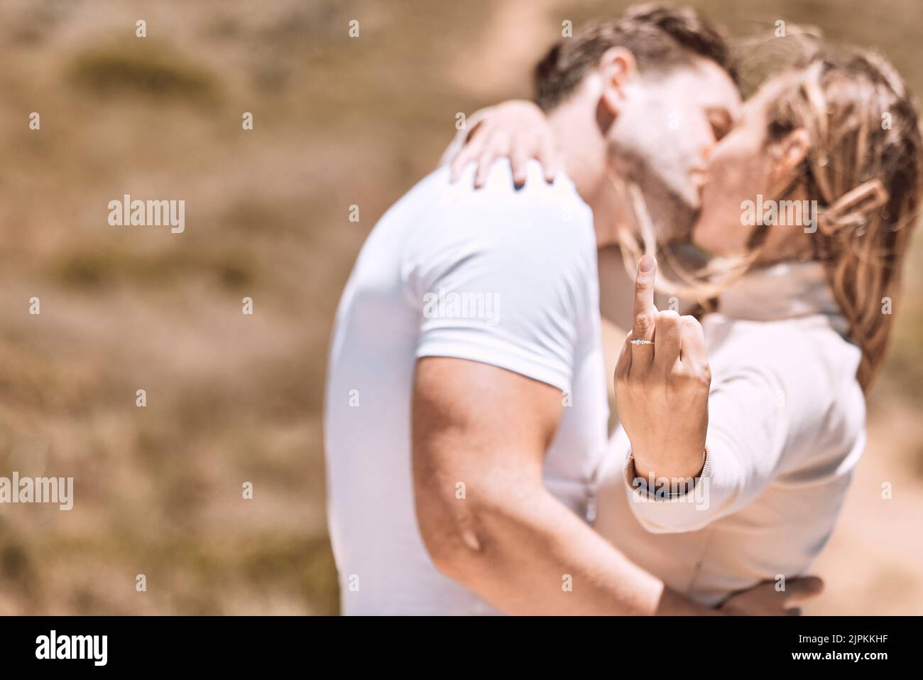 Eine junge Frau zeigt ihren Verlobungsring, während das Paar sich küsst und gemeinsam einen süßen Moment genießt. Verliebt, romantisch und küssen Paar bereit für Stockfoto